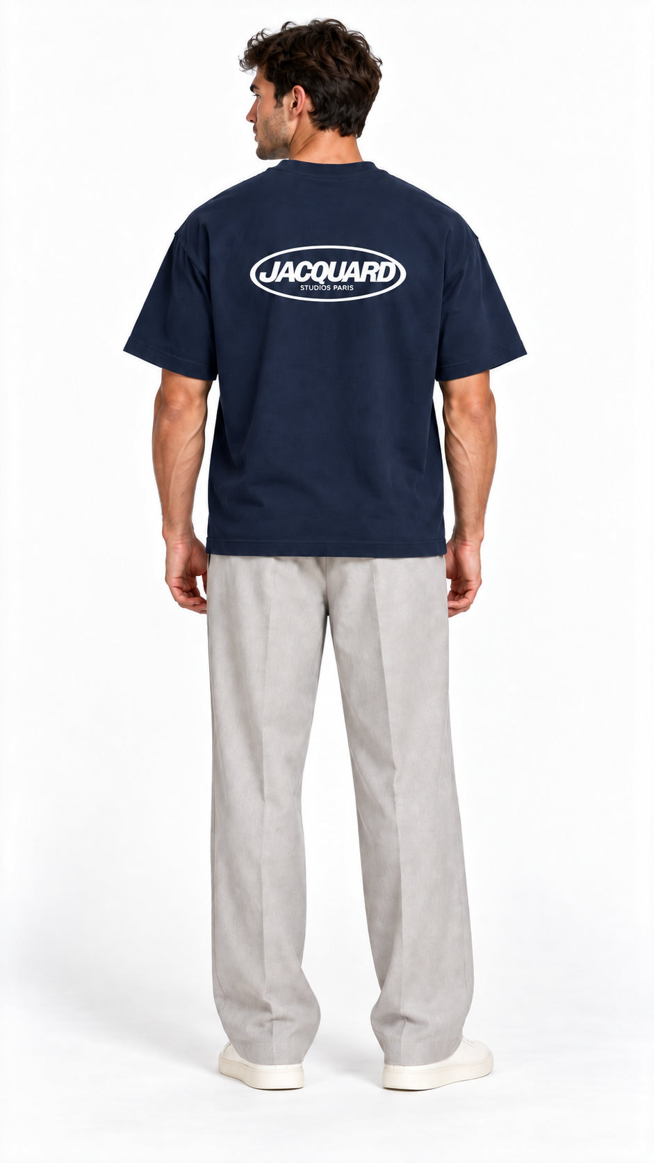 Back view of a model wearing the JacquardStudios Logo T-Shirt in Navy Blue