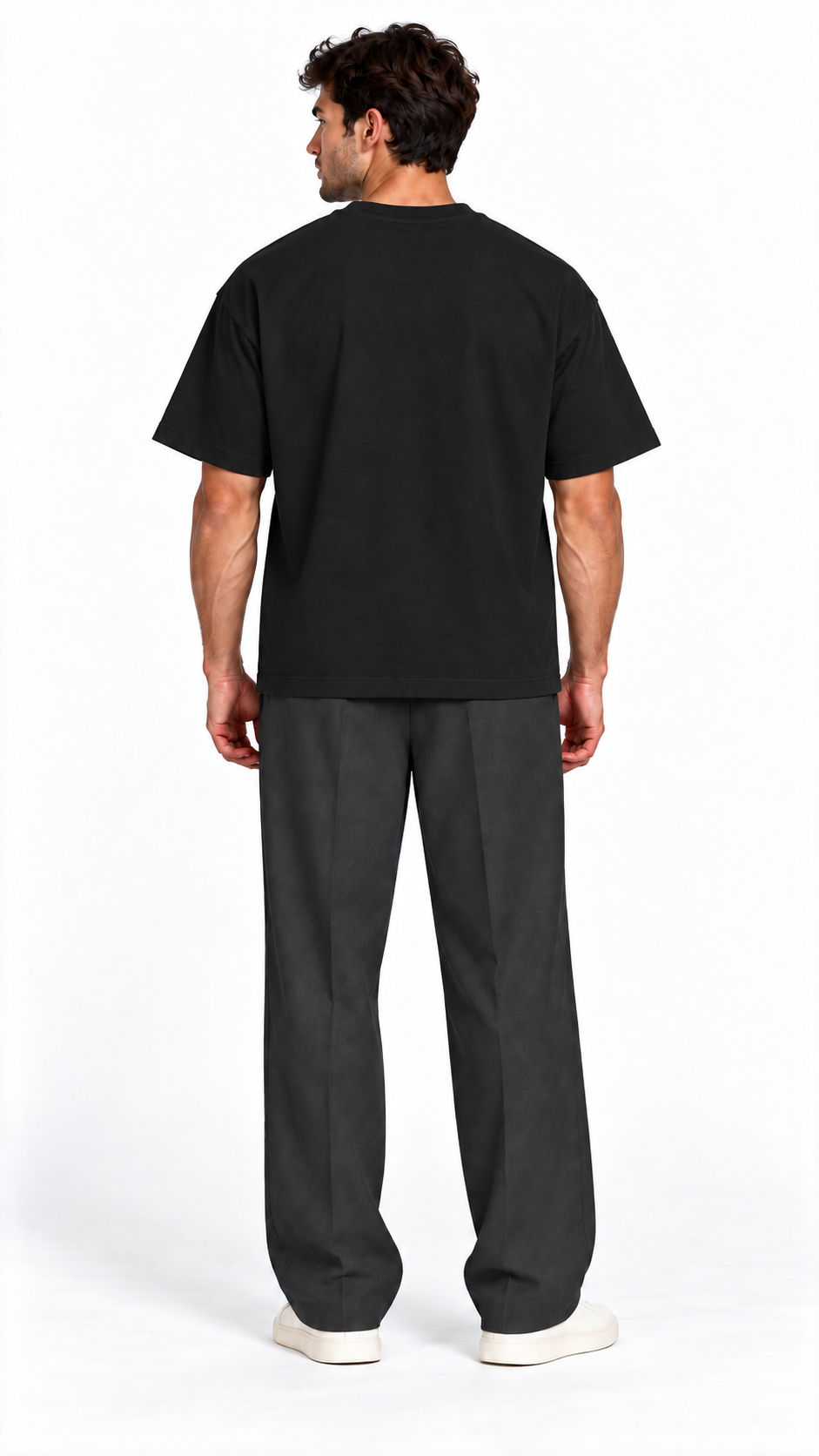 Back view of a model wearing the JacquardStudios Defined by T-Shirt in Black