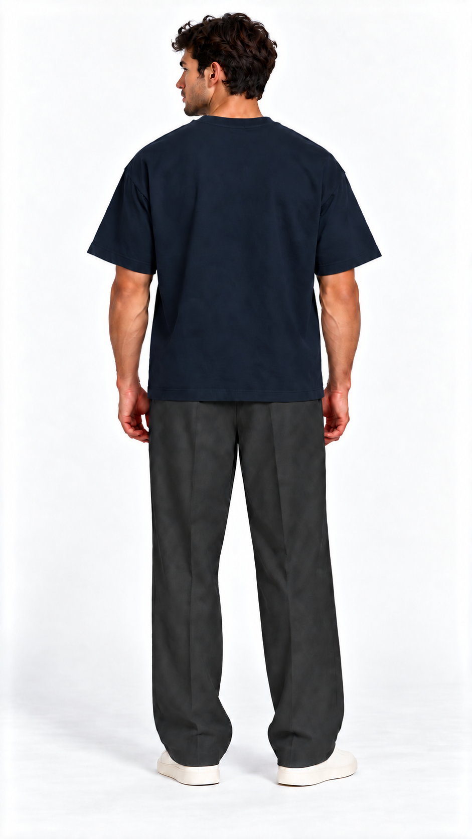 Back view of a model wearing the JacquardStudios Defined by T-Shirt in Navy Blue