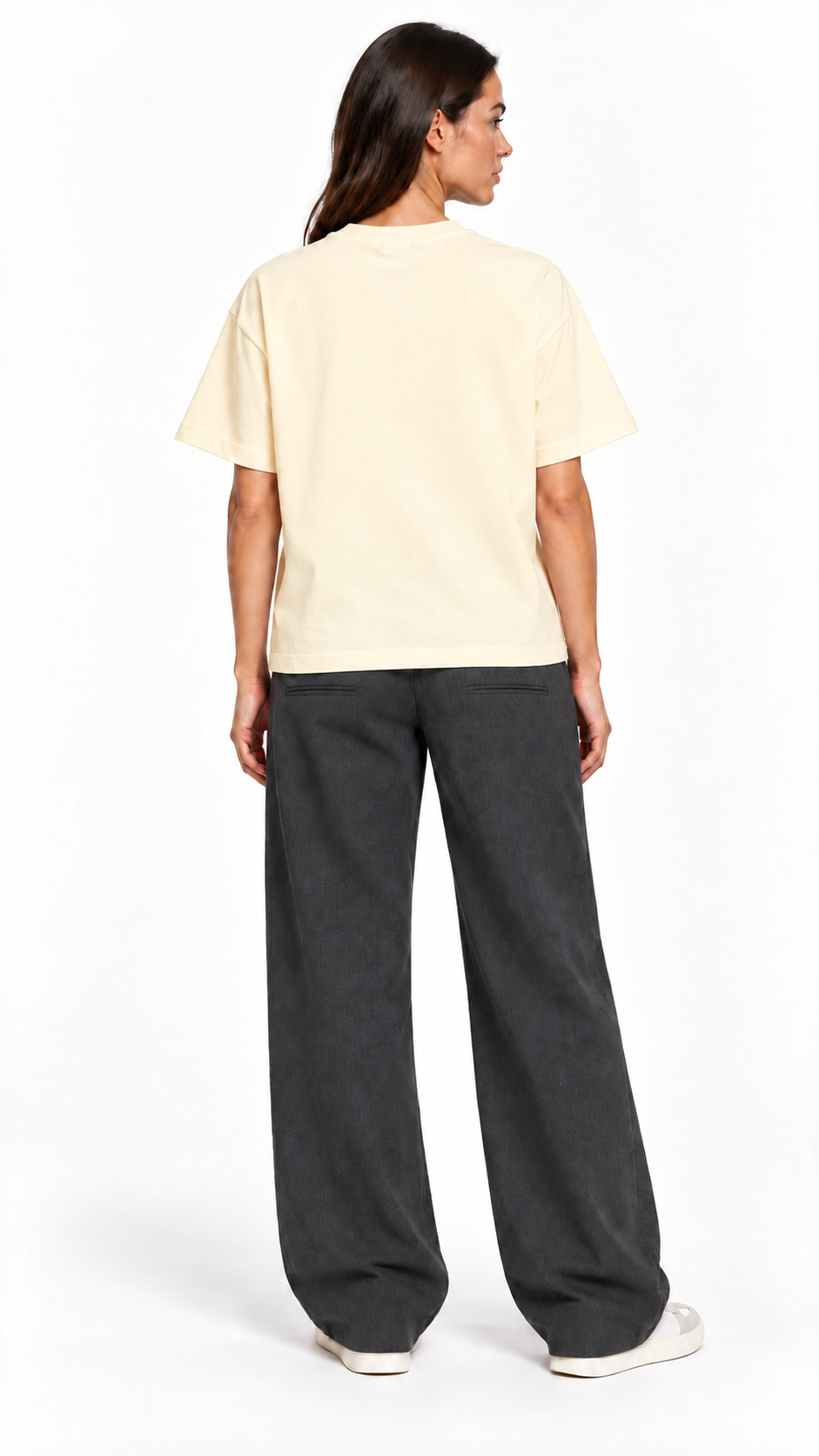 Back view of a second model wearing the JacquardStudios Defined by T-Shirt in Apricot