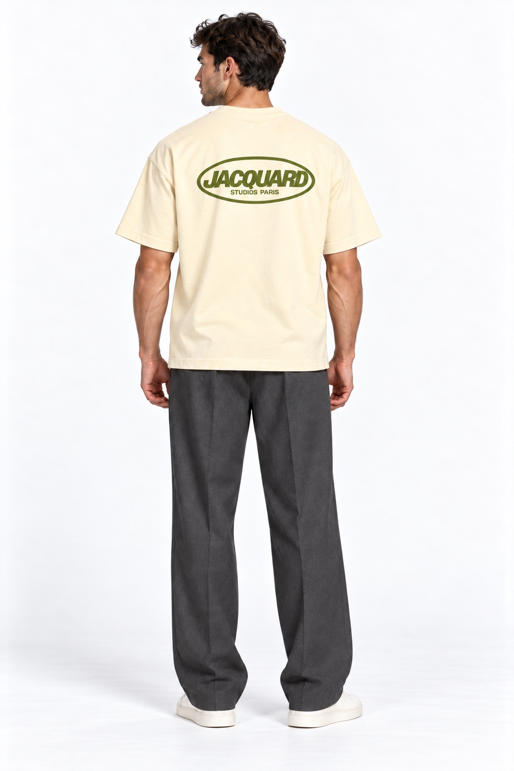 Back view of a model wearing the JacquardStudios Logo T-Shirt in Apricot