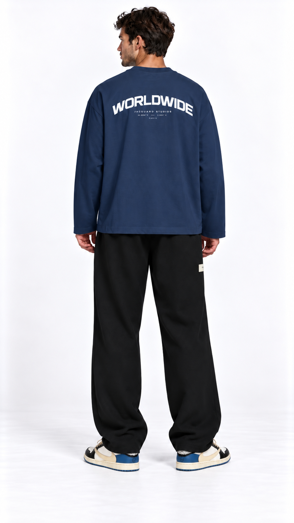 Back view of a model wearing the JacquardStudios Worldwide Longsleeve in Navy Blue