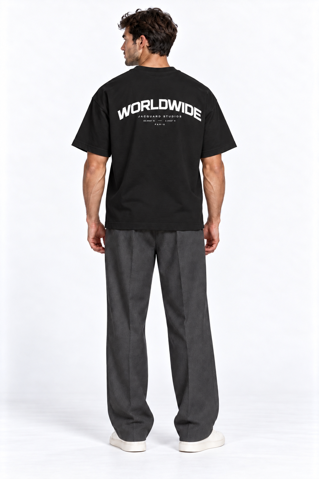 Back view of a model wearing the JacquardStudios Worldwide T-Shirt in Black