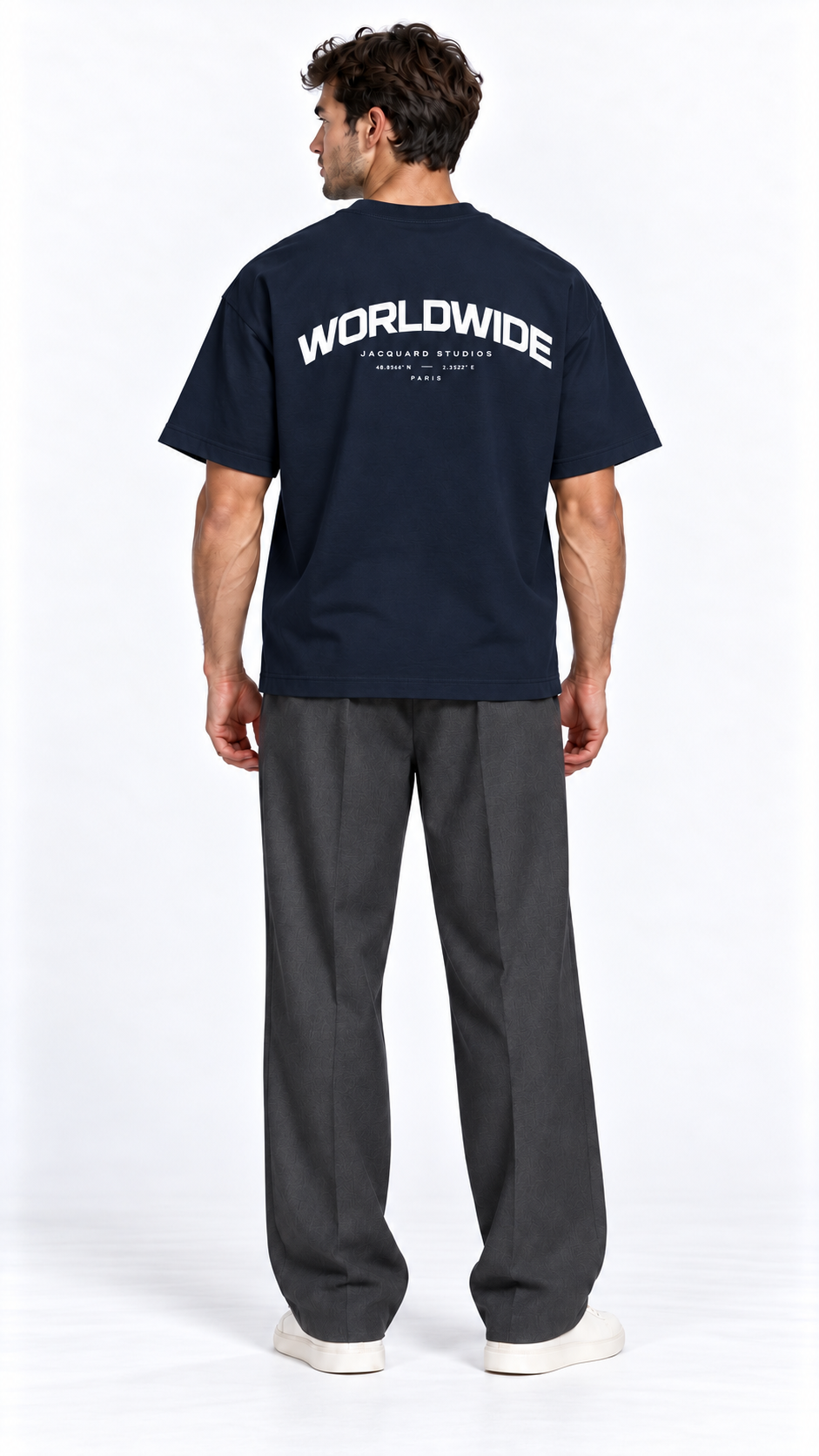Back view of a model wearing the JacquardStudios Worldwide T-Shirt in Navy Blue